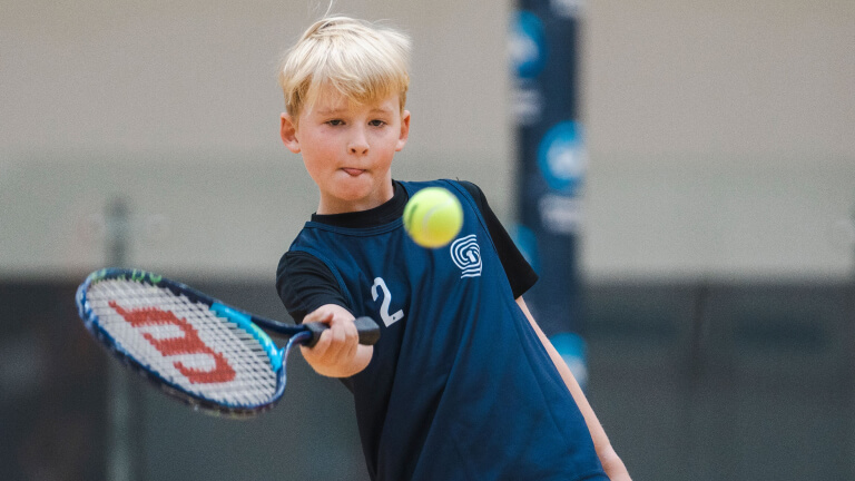 Young boy playing tennis at a Sporskey testing event