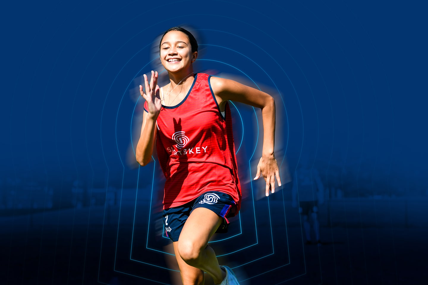 Young girl running and smiling during Sportskey test